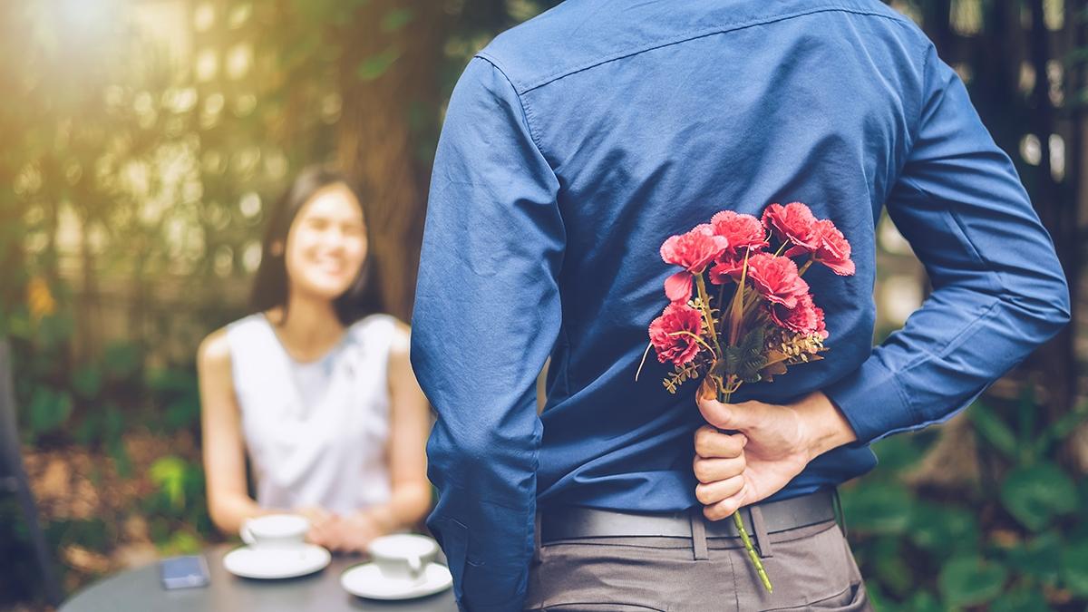 Article Cards Featured Image The man is hiding red flowers behind him in order to surprise hi