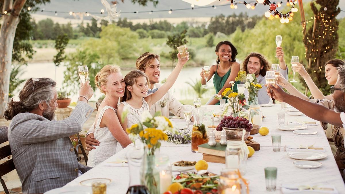 Young couple guests toasting champagne during wedding reception