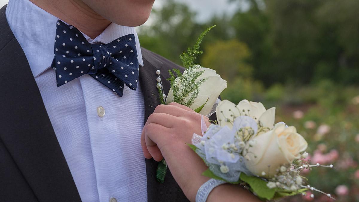 pinning boutonniere and corsage for prom or formal