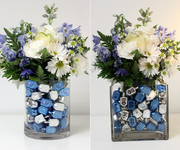Hanukkah centerpiece with a vase full of dreidels and flowers.