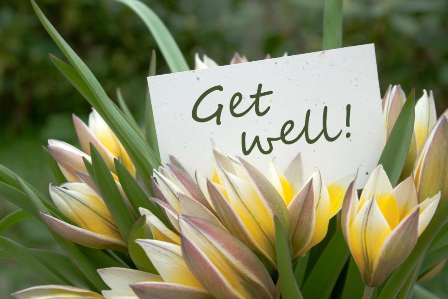 Photo of a get well message with a bouquet of flowers