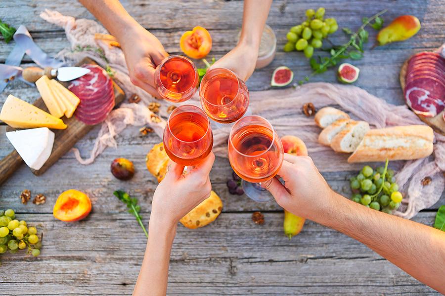 rose pairings with friends toasting at an outdoor meal