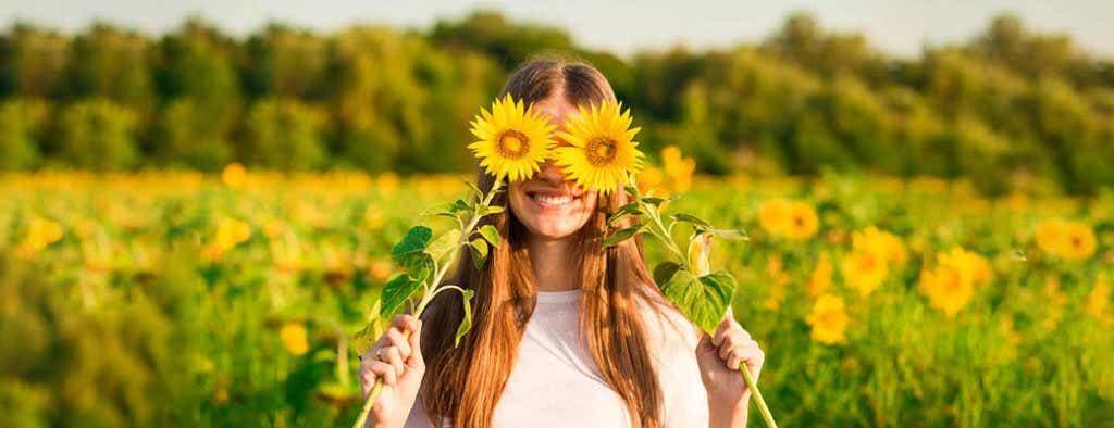 Woman with sunflowers over eyes