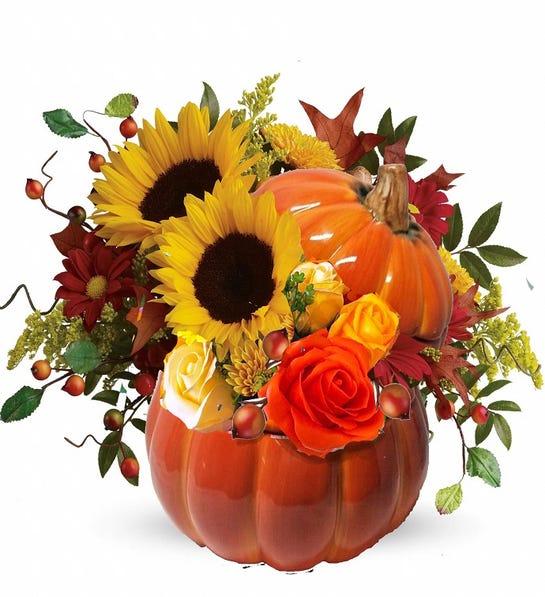 Photo of a ceramic pumpkin flower arrangement, a great way to boost the Halloween decor of your living room's coffee table.