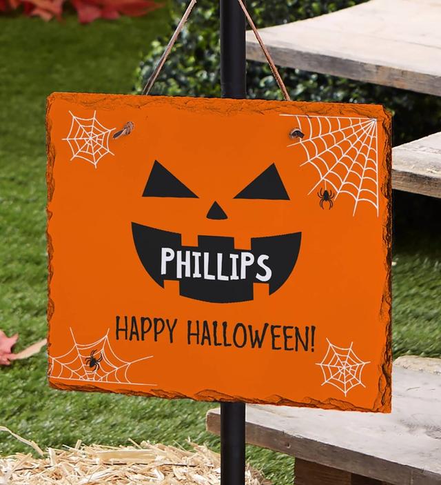 Photo of a personalized lawn sign that greets trick or treaters.