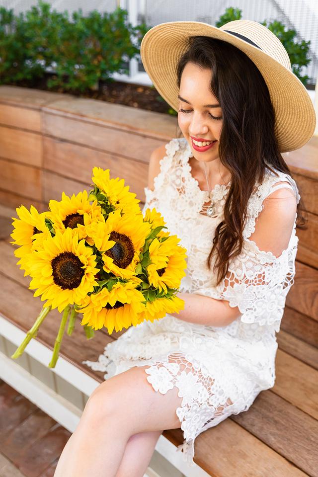 sunflower symbolism women holding sunflowers