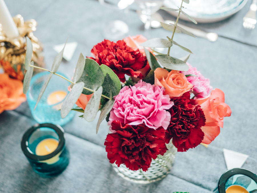 Carnation bouquet in glass vase on table