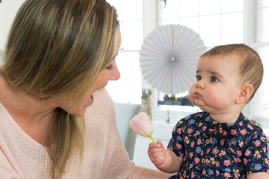 https://www.flowers.com/blog/wp content/uploads///mom and baby with flower