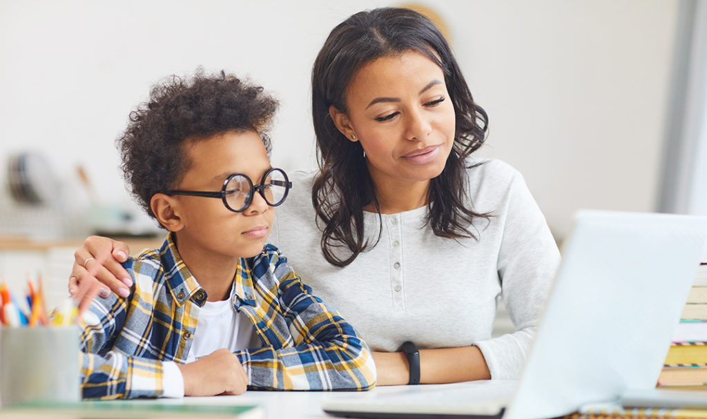 Two kids using a laptop