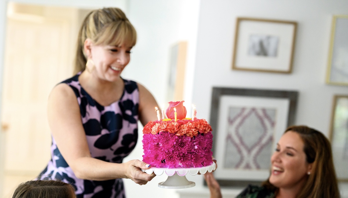 Photo of flower birthday cake a component of the dinner party theme