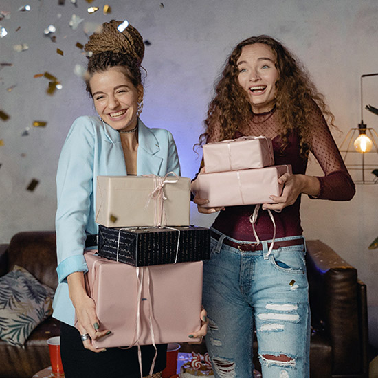 a photo of a surprise birthday party: friends holding presents