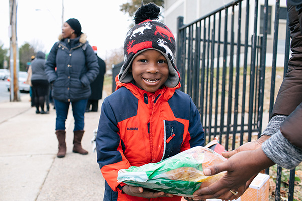 https://www.flowers.com/blog/wp content/uploads///feeding america child holds bread