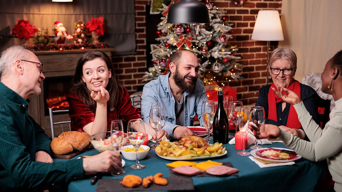 https://www.flowers.com/blog/wp content/uploads///grief during the holidays with family sitting around table talking