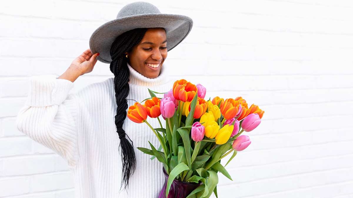 birthday gifts for aries with woman holding bouquet of tulips