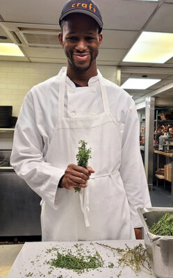 Photo of Manny Irick in the kitchen of restaurant. He was hired through Smile Farms, which helps create
jobs for people with disabilities