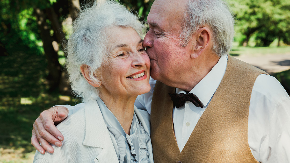 Old couple is walking in the green park. Grandmother and grandfa