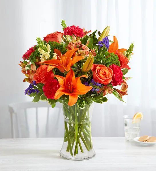 https://www.1800flowers.com/blog/wp-content/uploads/2023/11/types_of_orange_flowers_Vibrant_Floral_Medley.webp